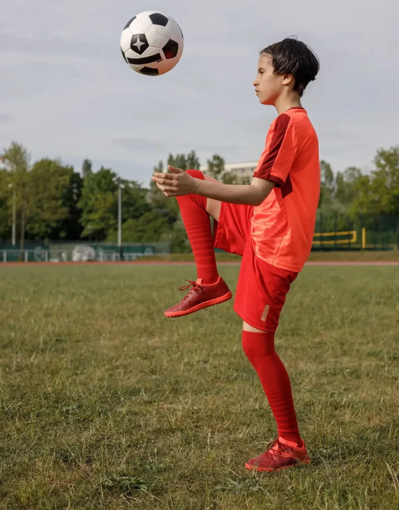 girl kicking the soccer ball with her knee 2023 11 27 05 33 17 utc scaled 1 e1752512333850