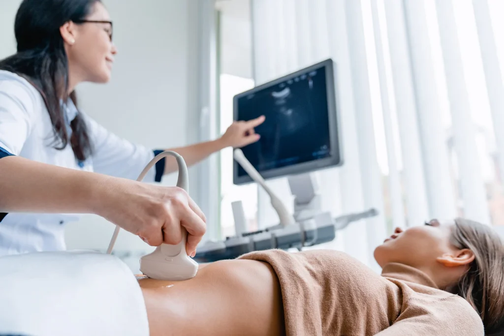 woman receiving ultrasound scan in bright medical 1